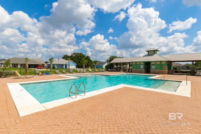 view of swimming pool with a patio area