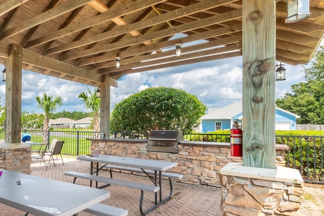 17589 Lewis Smith Dr, Foley, AL 36535 - view of patio with exterior kitchen, a grill, fence, and outdoor dining area