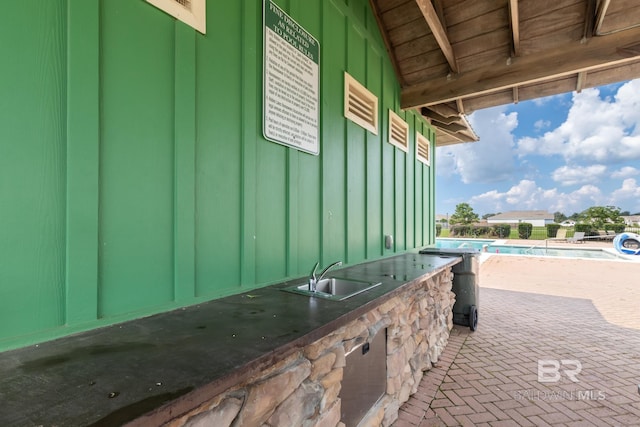 view of patio featuring area for grilling and sink