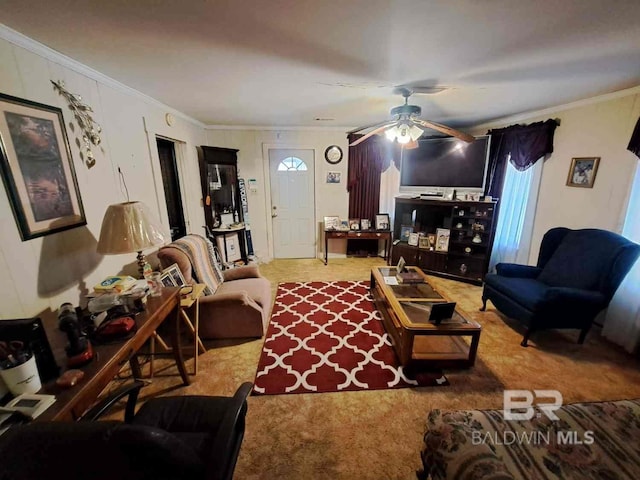 living area featuring carpet, ornamental molding, and ceiling fan