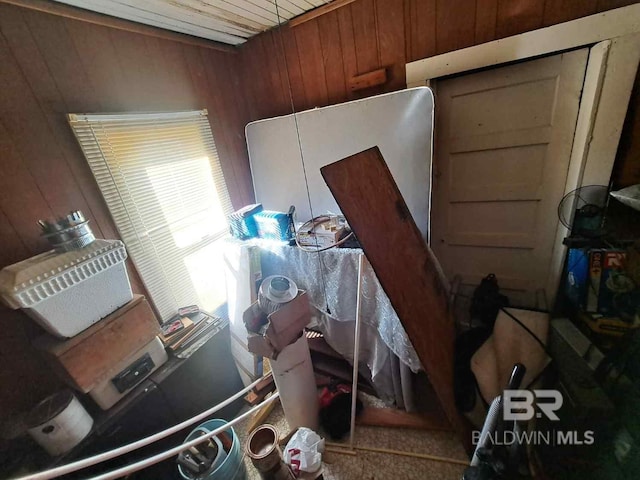 misc room featuring wooden walls