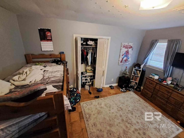 bedroom with a closet and baseboards