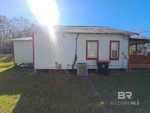 view of home's exterior featuring central AC and a lawn