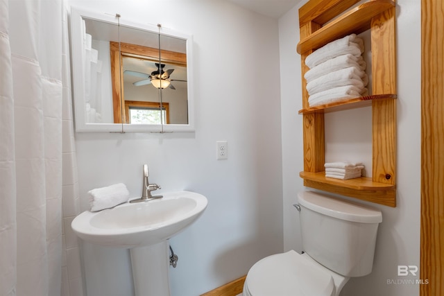 bathroom featuring a sink, ceiling fan, and toilet