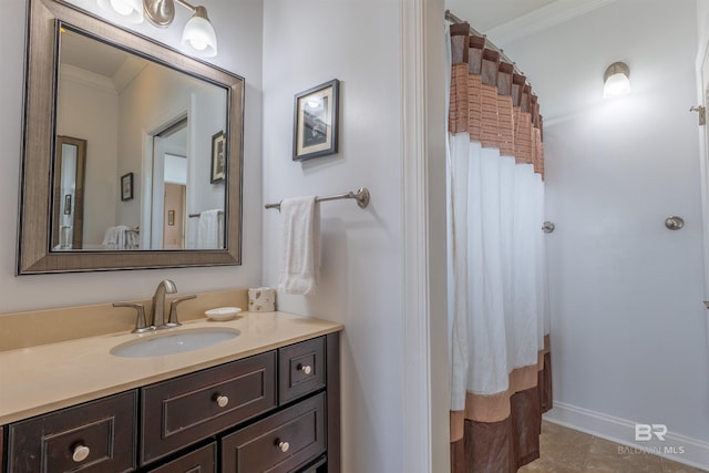 full bath featuring baseboards, tile patterned floors, curtained shower, crown molding, and vanity