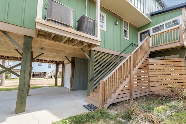 exterior space featuring an attached garage, a carport, and board and batten siding