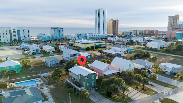 birds eye view of property with a view of city and a water view