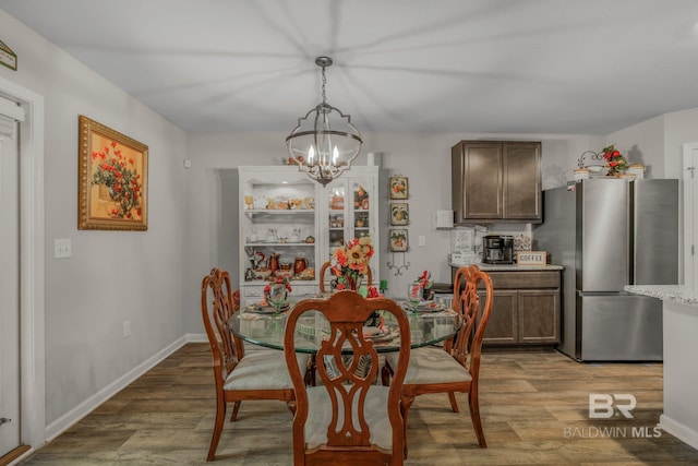 dining room with hardwood / wood-style flooring and a chandelier