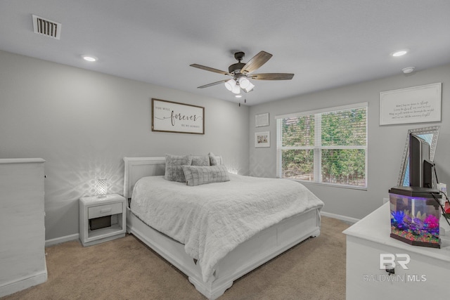 bedroom with light carpet and ceiling fan