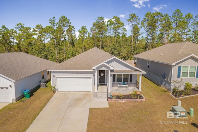 view of front of house with covered porch, a front lawn, a garage, and central AC