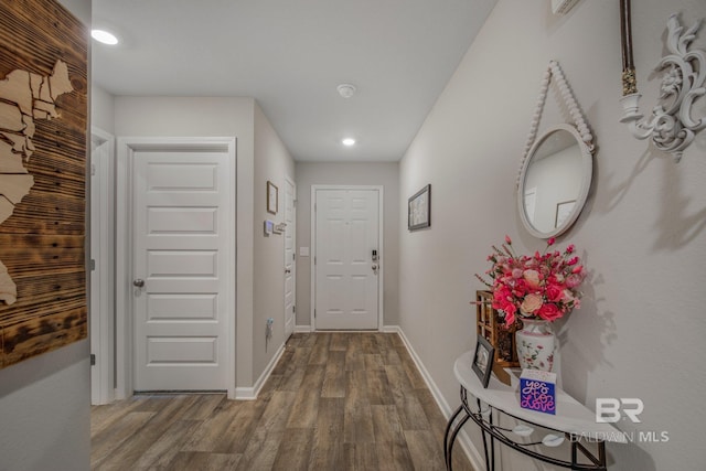 corridor with hardwood / wood-style flooring