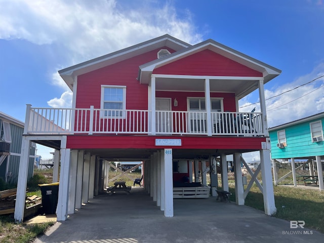 403 E Bernard Ct, Gulf Shores, AL 36542 - coastal home with a carport, a porch, and concrete driveway