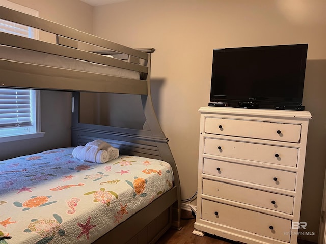 bedroom with dark hardwood / wood-style floors