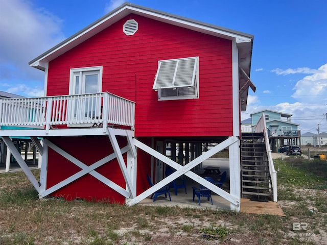 back of house with a wooden deck