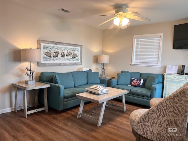 living room featuring dark hardwood / wood-style flooring and ceiling fan