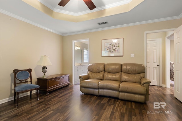 1521 E Peyton Dr, Mobile, AL 36695 - living room featuring dark wood-style flooring, a tray ceiling, a ceiling fan, crown molding, and baseboards