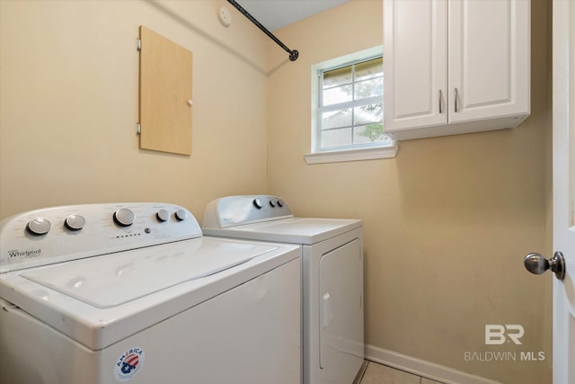 1521 E Peyton Dr, Mobile, AL 36695 - laundry area with cabinet space, washing machine and dryer, baseboards, and light tile patterned floors