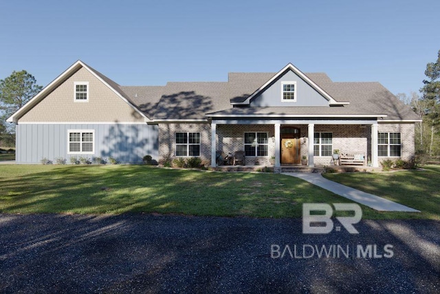 view of front of house with a front yard and covered porch