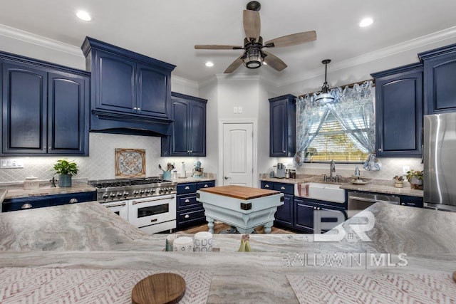 kitchen with ornamental molding, appliances with stainless steel finishes, sink, blue cabinets, and ceiling fan