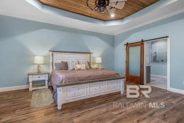 bedroom featuring ensuite bath, wood ceiling, a raised ceiling, a barn door, and dark hardwood / wood-style flooring