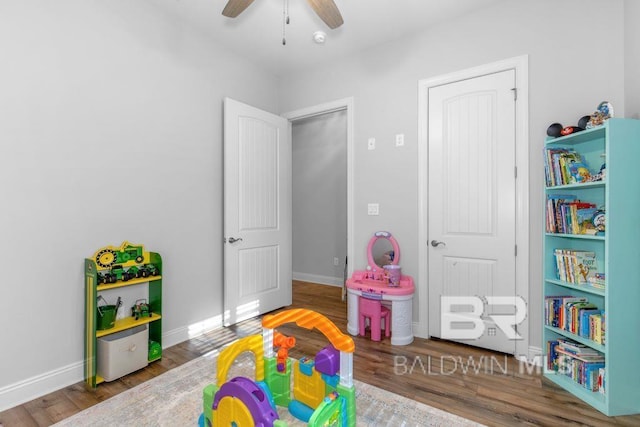 recreation room featuring hardwood / wood-style flooring and ceiling fan