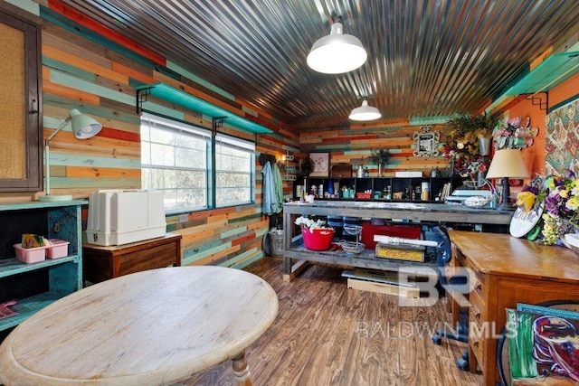 game room with wood walls and wood-type flooring