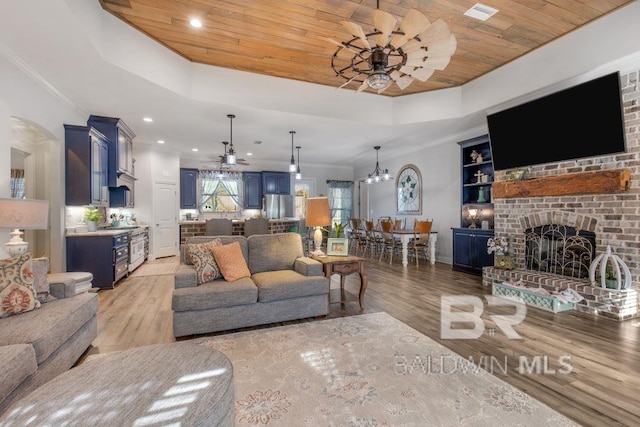 living room featuring wooden ceiling, light hardwood / wood-style floors, a fireplace, and built in features