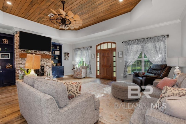 living room with a tray ceiling, wooden ceiling, and light hardwood / wood-style flooring