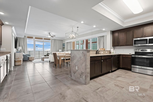 kitchen featuring sink, stainless steel appliances, ceiling fan with notable chandelier, and ornamental molding
