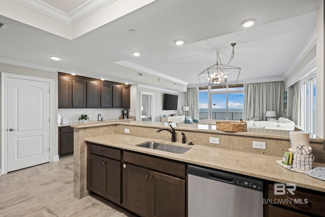 kitchen with dark brown cabinetry, light stone countertops, dishwasher, sink, and a notable chandelier