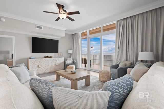 living room featuring crown molding and ceiling fan