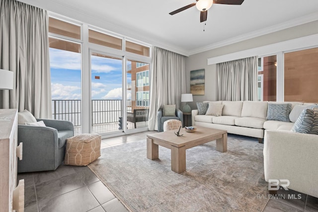 tiled living room featuring ceiling fan and crown molding
