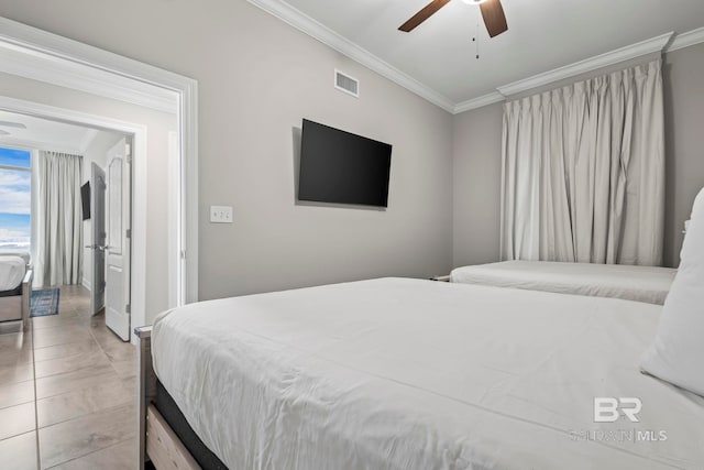 bedroom with ceiling fan, light tile patterned floors, and crown molding
