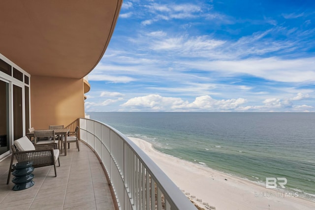 balcony featuring a water view and a beach view