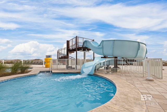 view of swimming pool featuring a patio area and a water slide