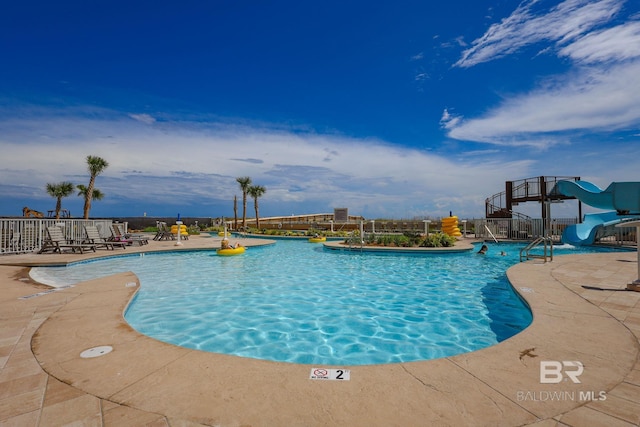 view of pool featuring a patio area and a water slide