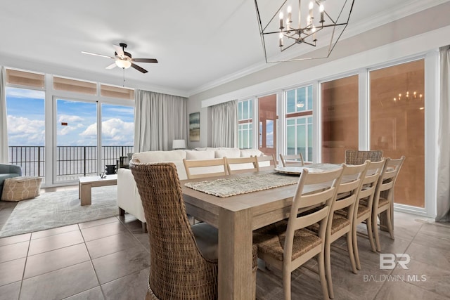 tiled dining area with a wealth of natural light, crown molding, and ceiling fan with notable chandelier