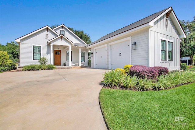 modern farmhouse with a garage and a front lawn