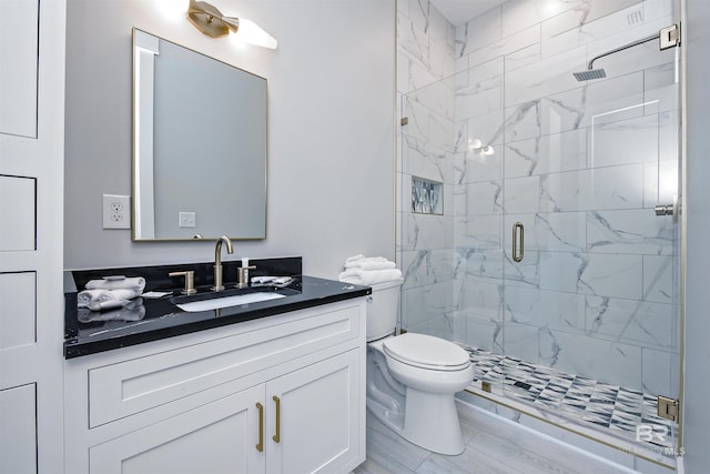 bathroom with vanity, toilet, and walk in shower