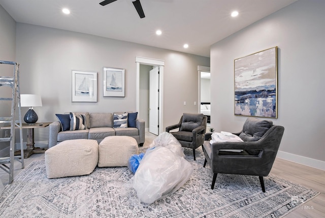 living room featuring hardwood / wood-style flooring and ceiling fan