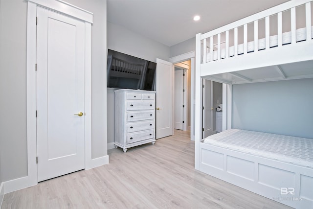 unfurnished bedroom featuring light wood-type flooring and a closet