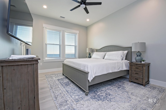 bedroom featuring lofted ceiling, ceiling fan, and light hardwood / wood-style floors