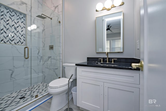 bathroom featuring walk in shower, ceiling fan, vanity, and toilet