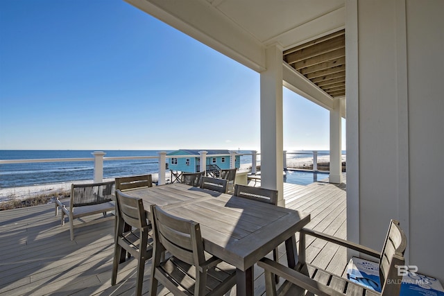 deck with a beach view and a water view