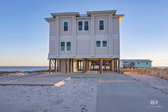 view of front of property featuring a carport and a water view