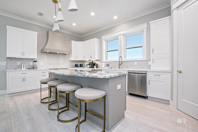 kitchen with white cabinetry, hanging light fixtures, custom exhaust hood, and dishwasher