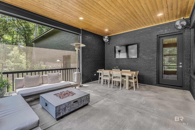 view of patio / terrace featuring an outdoor living space with a fire pit and outdoor dining space