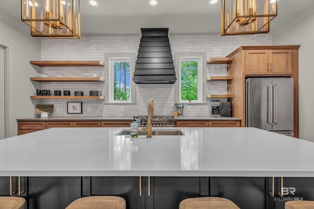 kitchen featuring open shelves, high end refrigerator, tasteful backsplash, a kitchen breakfast bar, and recessed lighting