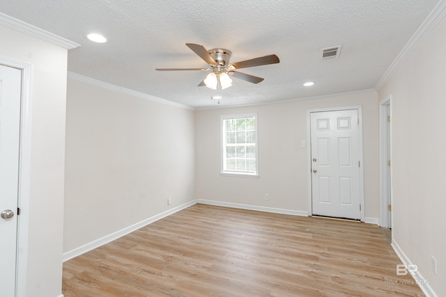 unfurnished room featuring a textured ceiling, light wood-type flooring, ceiling fan, and ornamental molding