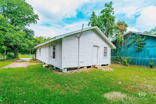 view of property exterior featuring a lawn